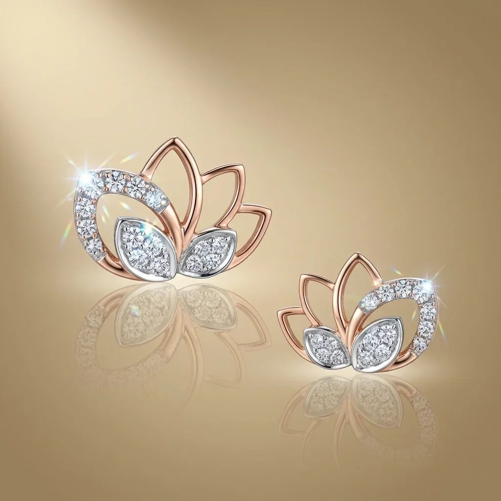 Lotus-shaped earrings with rose gold finish on a reflective gold surface.