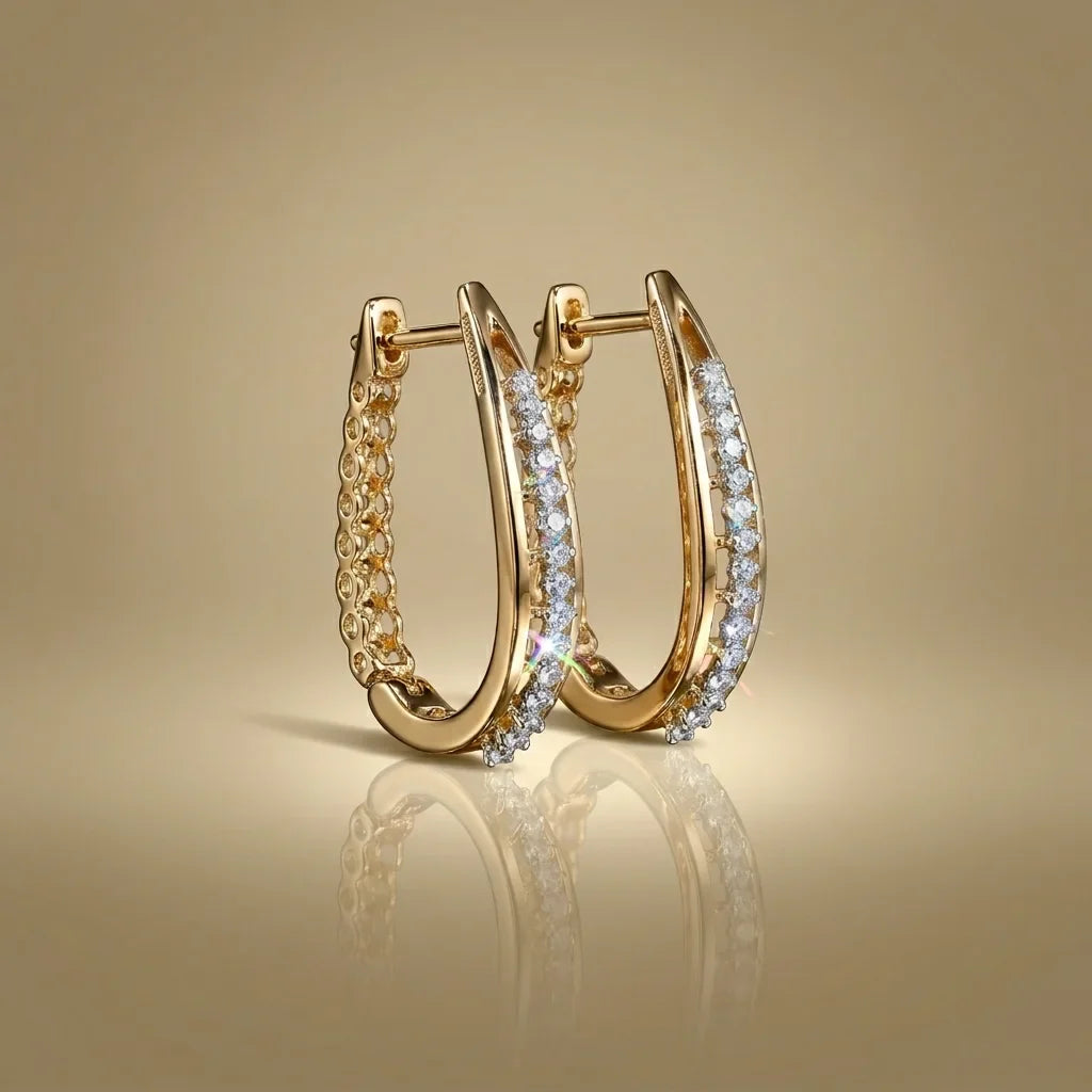 Gold hoop earrings with diamond accents on a gold background