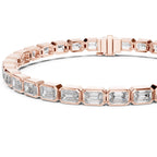 A rose gold tennis bracelet featuring emerald-cut clear diamonds, presented on a clean white background.