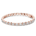 A rose gold tennis bracelet featuring rectangular emerald-shape clear diamonds in a continuous link design, shown against a plain white background.