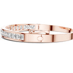 Rose gold bracelet with diamond accents on a white background