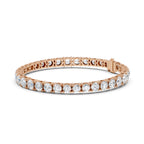 Rose gold bracelet with clear diamonds on a white background