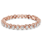 A rose gold tennis bracelet featuring oval brilliant-cut diamonds set in a continuous link design, shown against a plain white background.