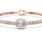 Rose gold bracelet with a central oval diamond and smaller round diamonds on a white background