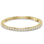 Gold bracelet with diamond accents on a white background