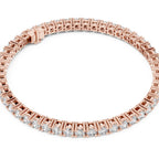 A rose gold tennis bracelet with a continuous line of small clear diamonds, shown on a plain white background.