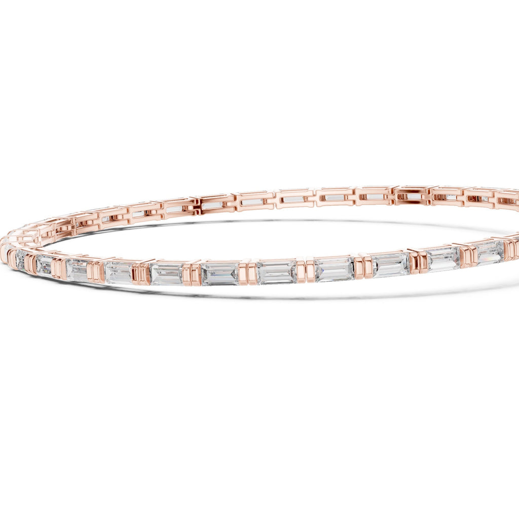 Gold bracelet with baguette-cut diamonds on a white background