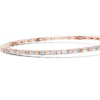Gold bracelet with baguette-cut diamonds on a white background