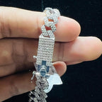 Gold chain bracelet held by a hand with a clear plastic bag underneath.