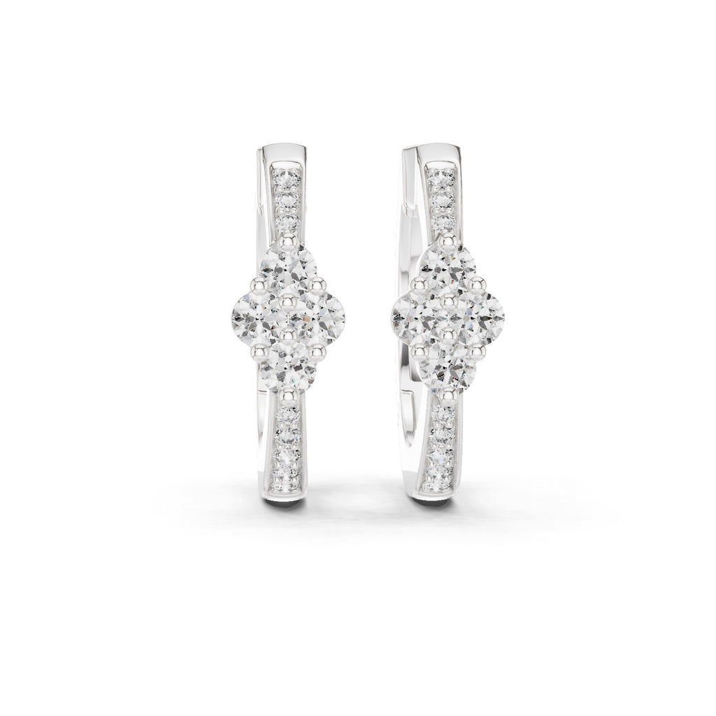 Pair of white gold diamond earrings on a white background