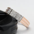 Rose gold ring with diamonds on a white background