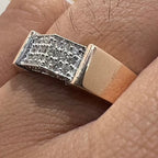 Close-up of a ring with diamond accents on a finger