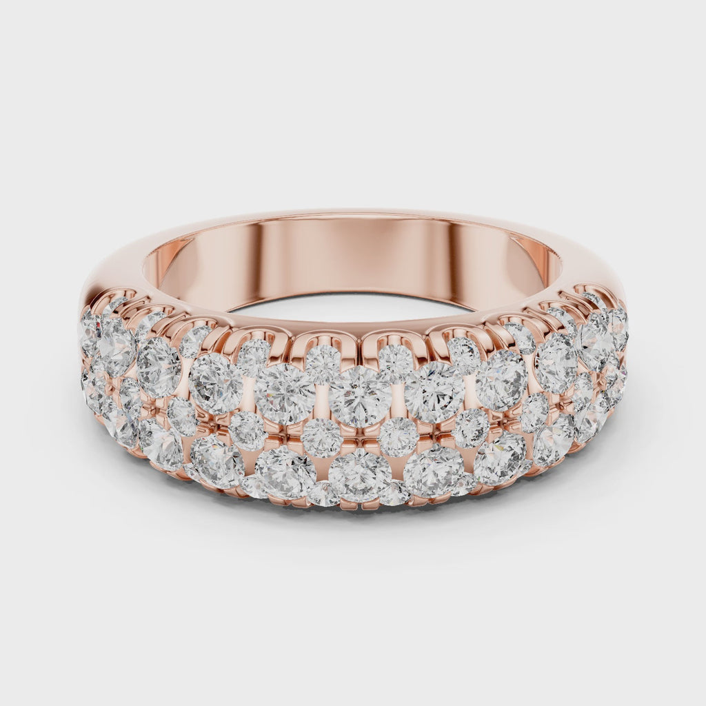 Rose gold ring with diamonds on a white background and surface is rotating parallel to the surface.
