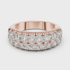 Rose gold ring with diamonds on a white background and surface is rotating parallel to the surface.