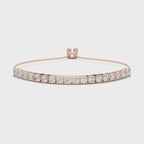 Rose gold bracelet with diamond accents on a white surface, is rotating parallel to the surface to show its view from all the sides.
