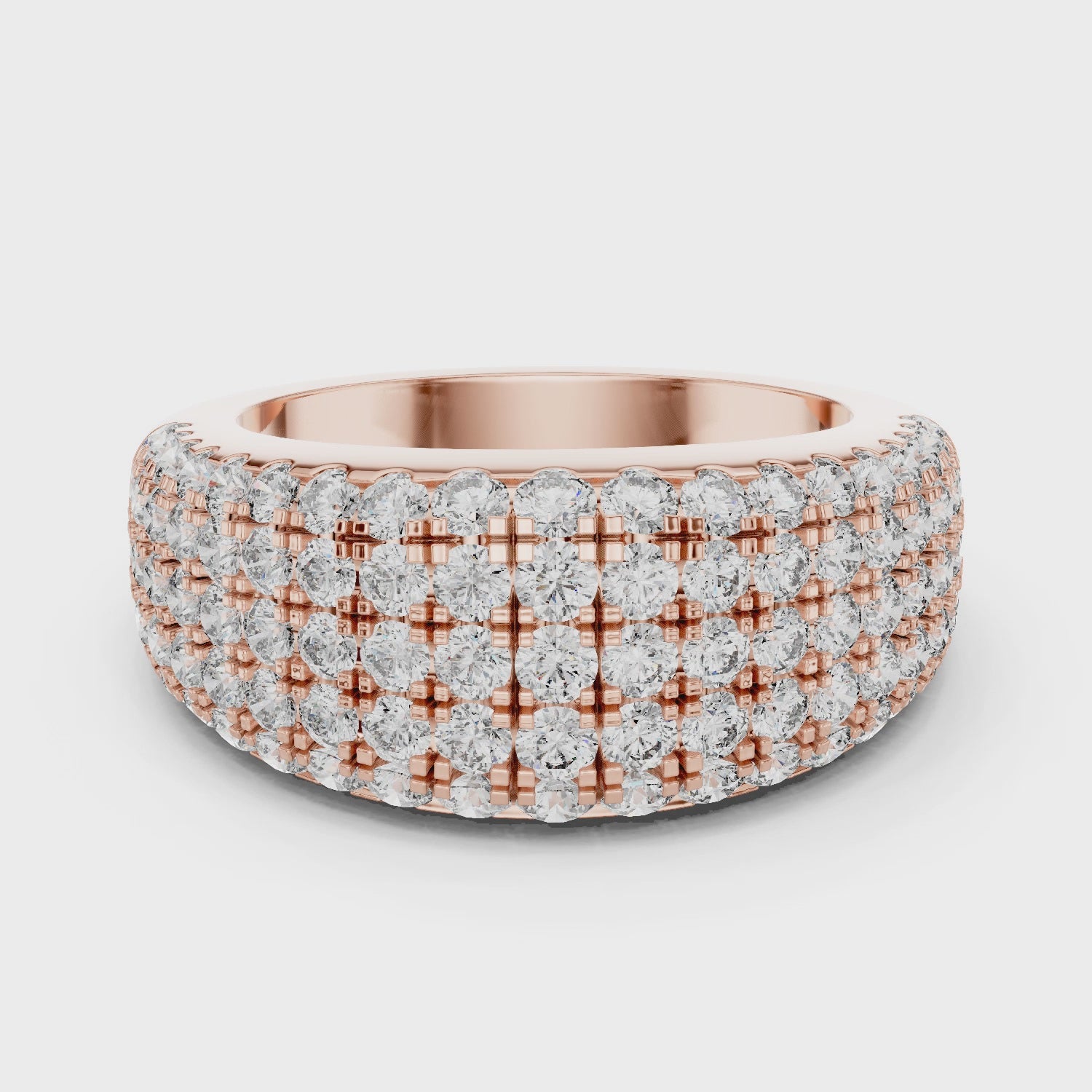 Rose gold ring with multiple row of diamonds on a white background is rotating parallel to the surface.