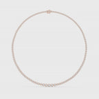 Tennis necklace with bezel-set natural diamonds is rotating horizontal on a white surface.