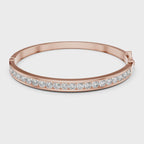 Rose gold bracelet with diamonds on a white background rotating parallel to the surface to show its view from every angle