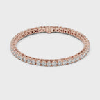A rose gold tennis bracelet with a continuous row of round-cut clear diamonds, displayed on a clean white surface and rotating parallel to the surface.