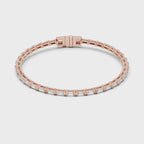 Rose gold and diamond tennis bracelet rotating parallel to the white surface to show its full view.