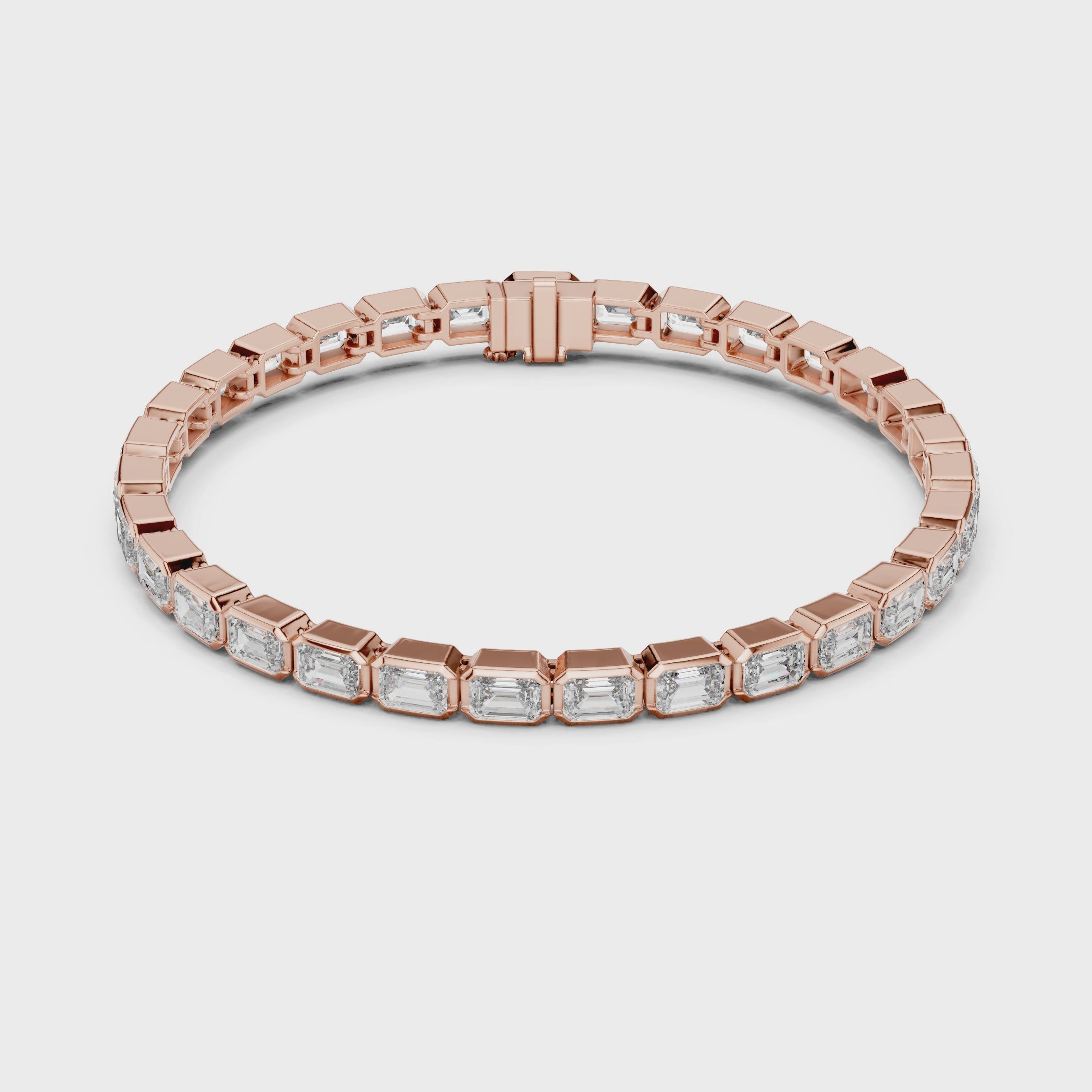 A rose gold tennis bracelet featuring rectangular emerald-shape clear diamonds in a continuous link design, shown on a plain white background and rotating parallel to the surface to show its view from every side.