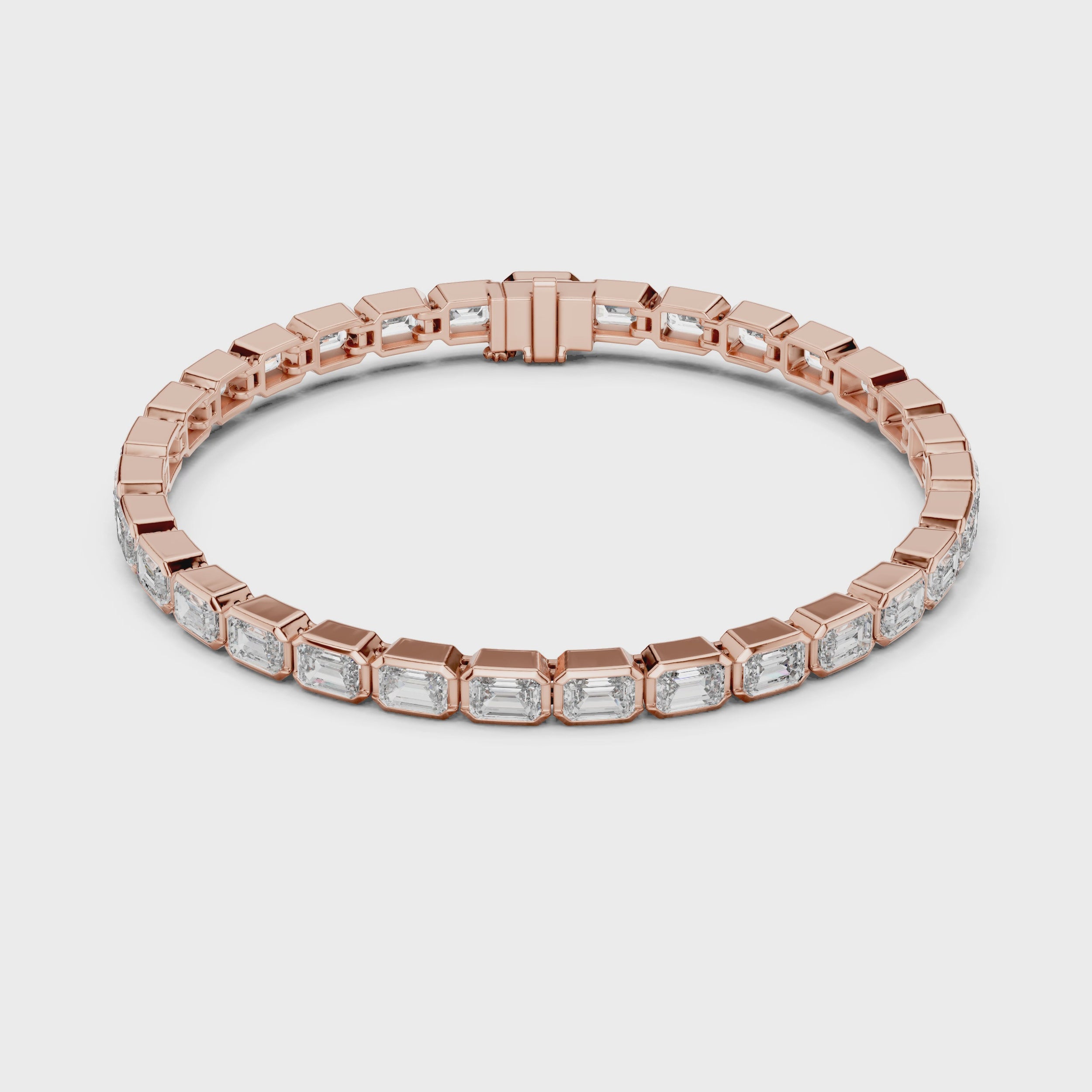A rose gold tennis bracelet featuring rectangular emerald-shape clear diamonds in a continuous link design, shown on a plain white background and rotating parallel to the surface to show its view from every side.