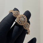 Rose gold bracelet with diamond accents on a black glove against a neutral background