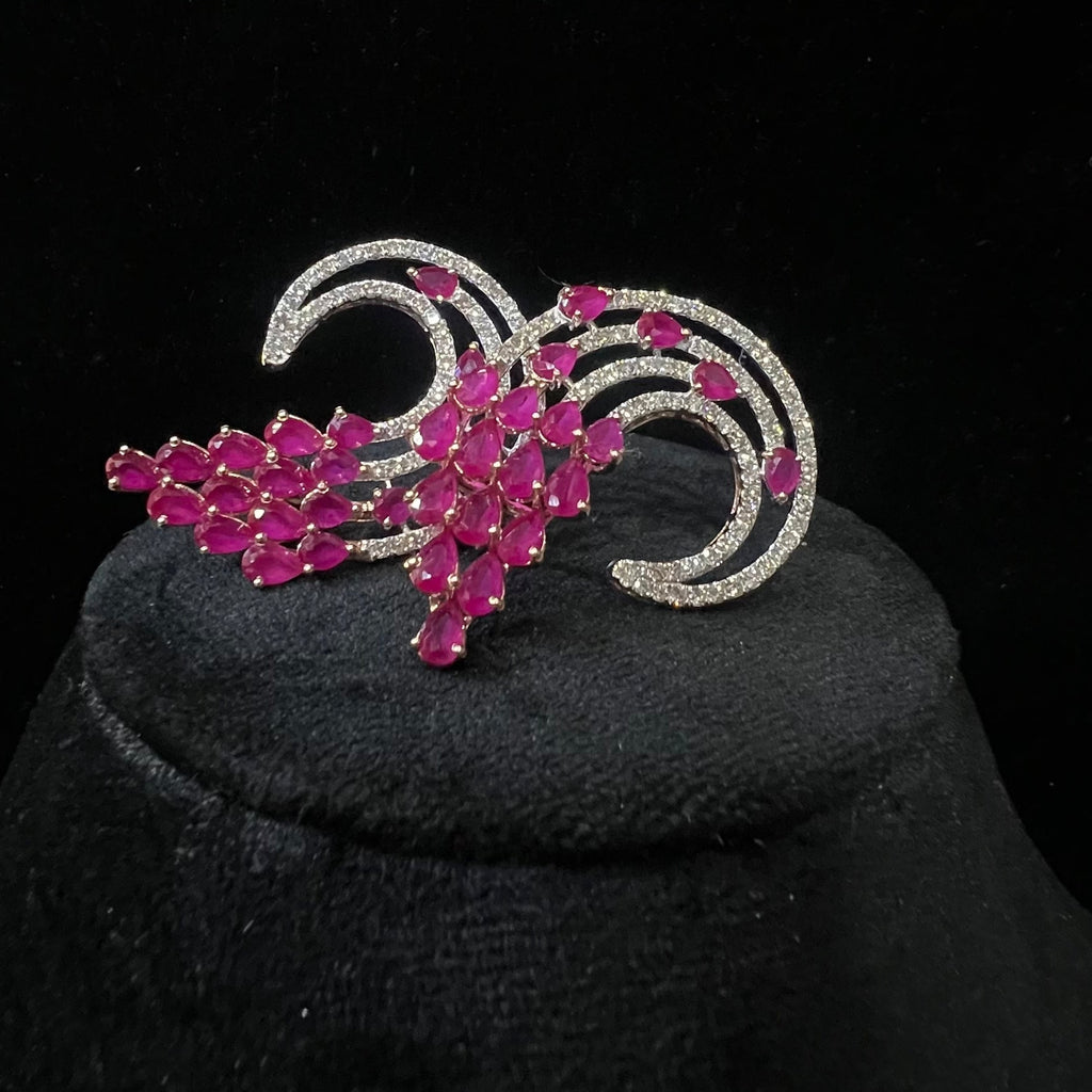 diamond stud earrings with pink gemstones on a black background
