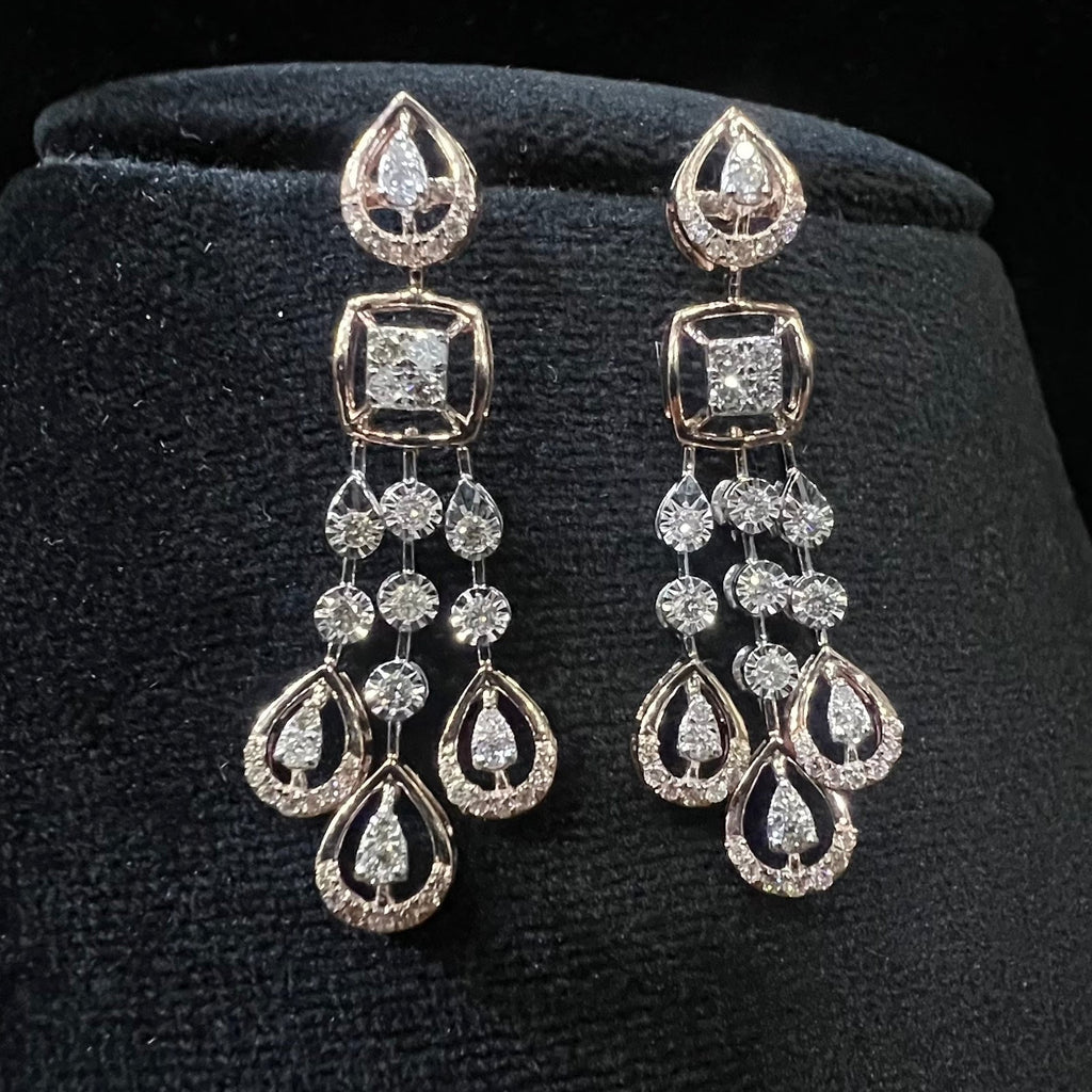 Pair of diamond earrings on a black velvet stand