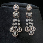 Pair of diamond earrings on a black velvet stand
