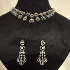Jewelry set with necklace and earrings on a black mannequin bust.