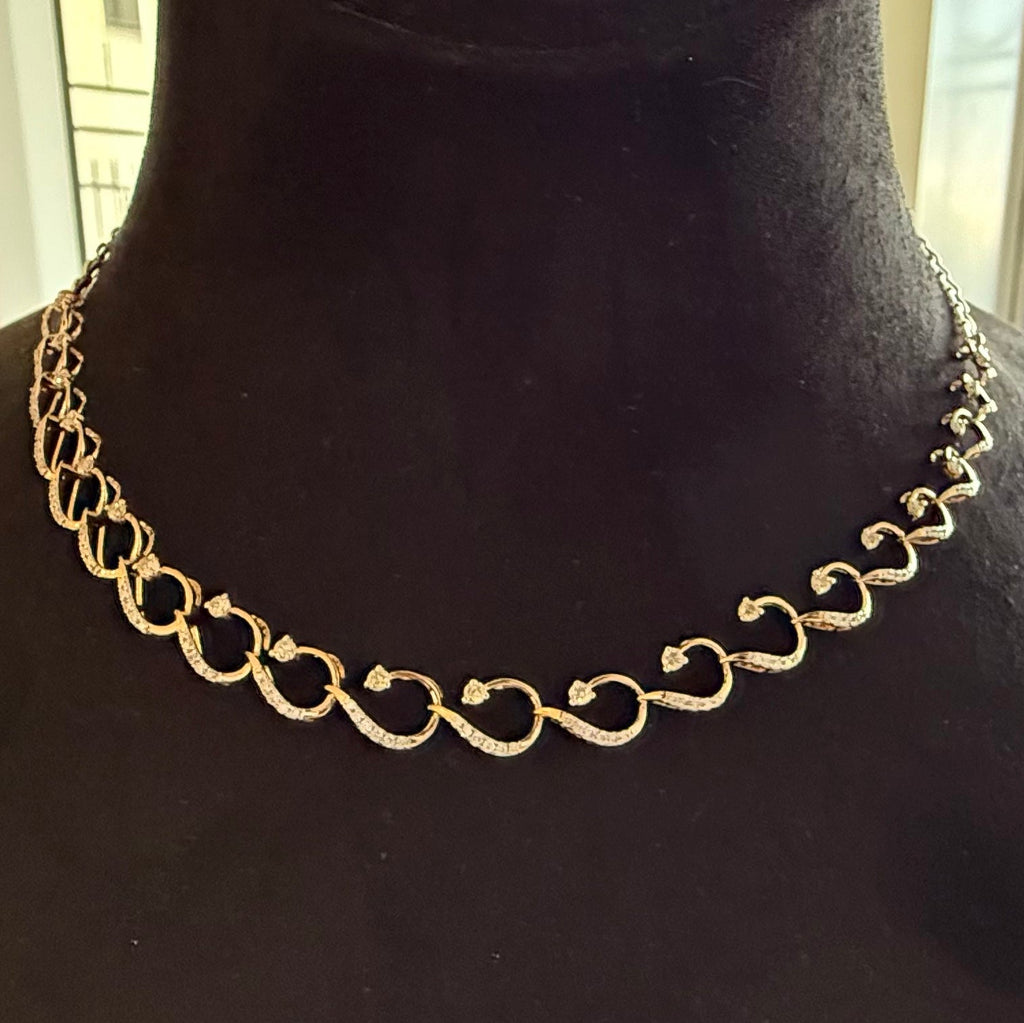 Gold diamond chain necklace on a black mannequin