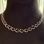 Gold diamond chain necklace on a black mannequin