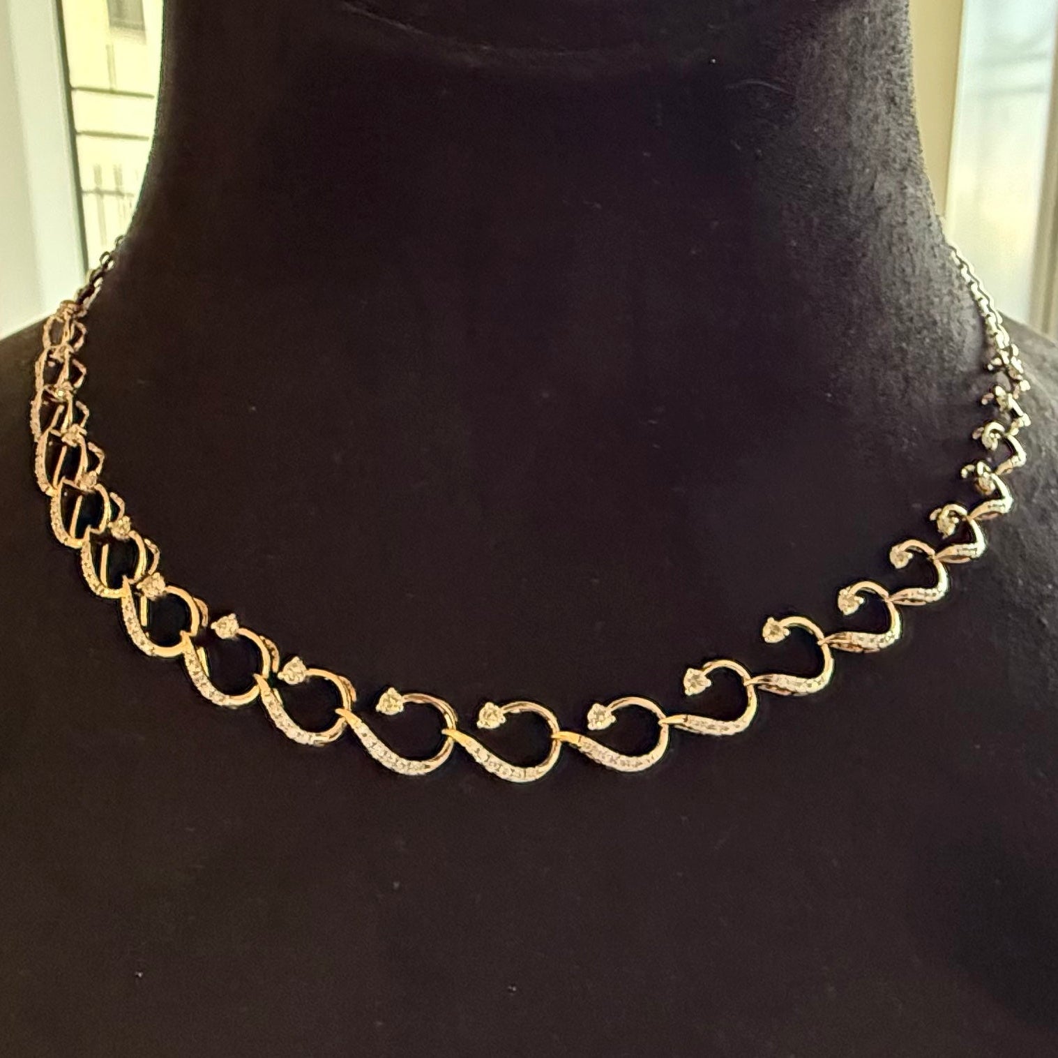 Gold diamond chain necklace on a black mannequin