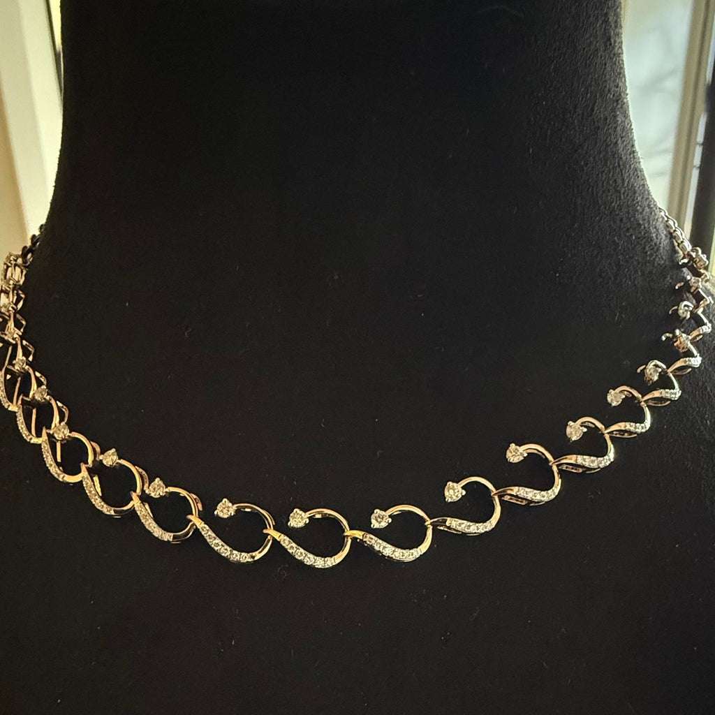 Gold diamond necklace on a black mannequin bust
