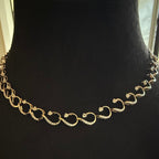 Gold diamond necklace on a black mannequin bust