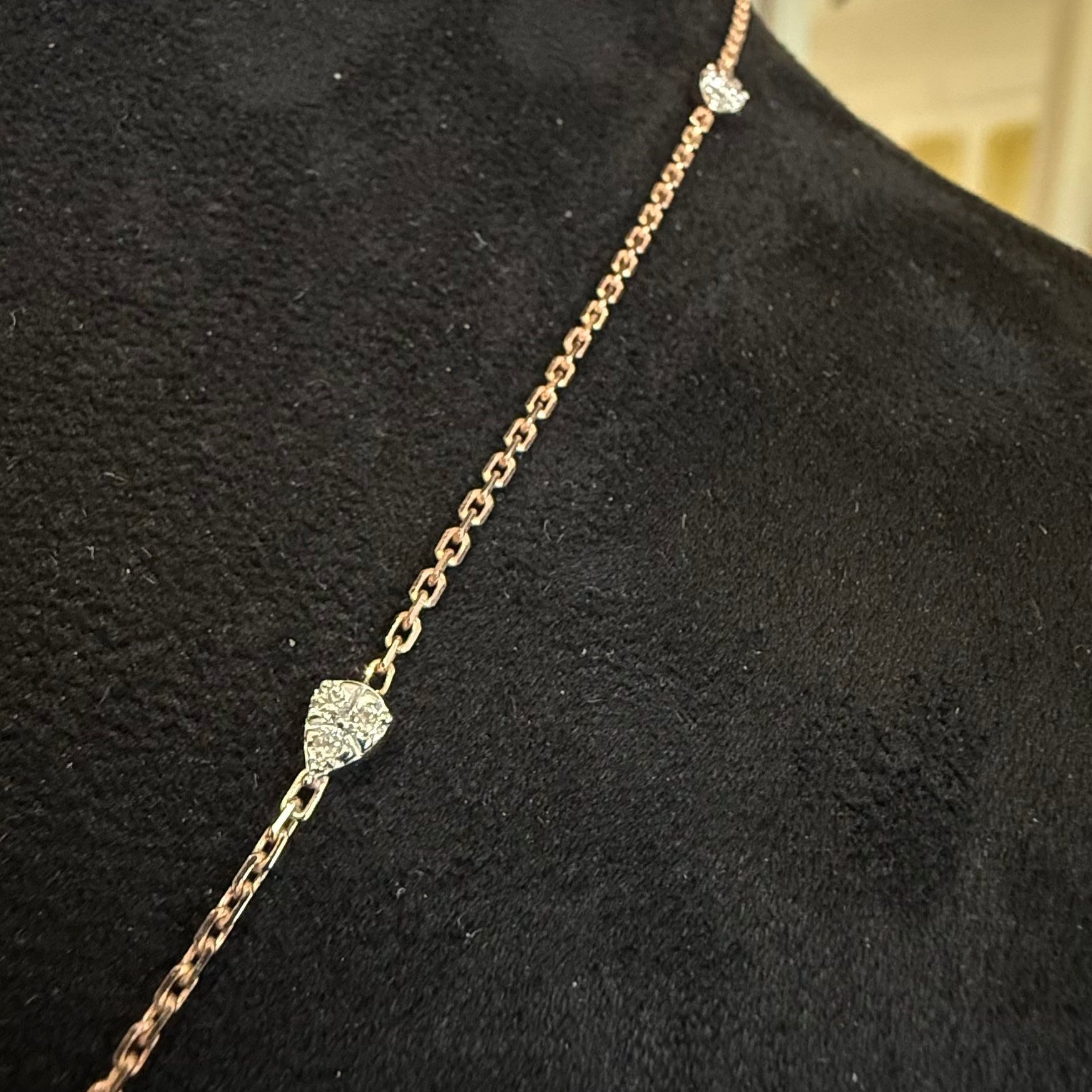 Gold necklace with diamonds on a black mannequin