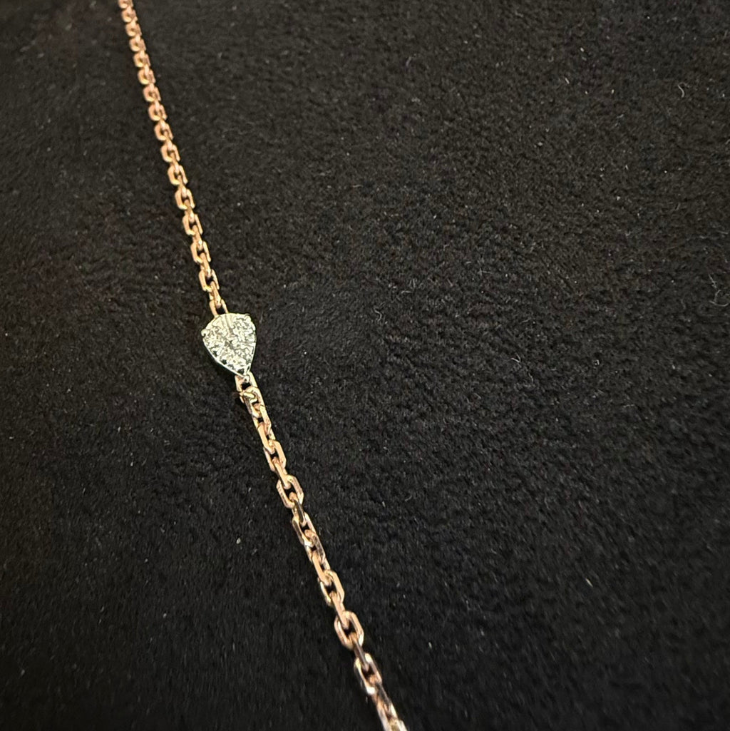 Gold chain necklace with a diamonds on a black background