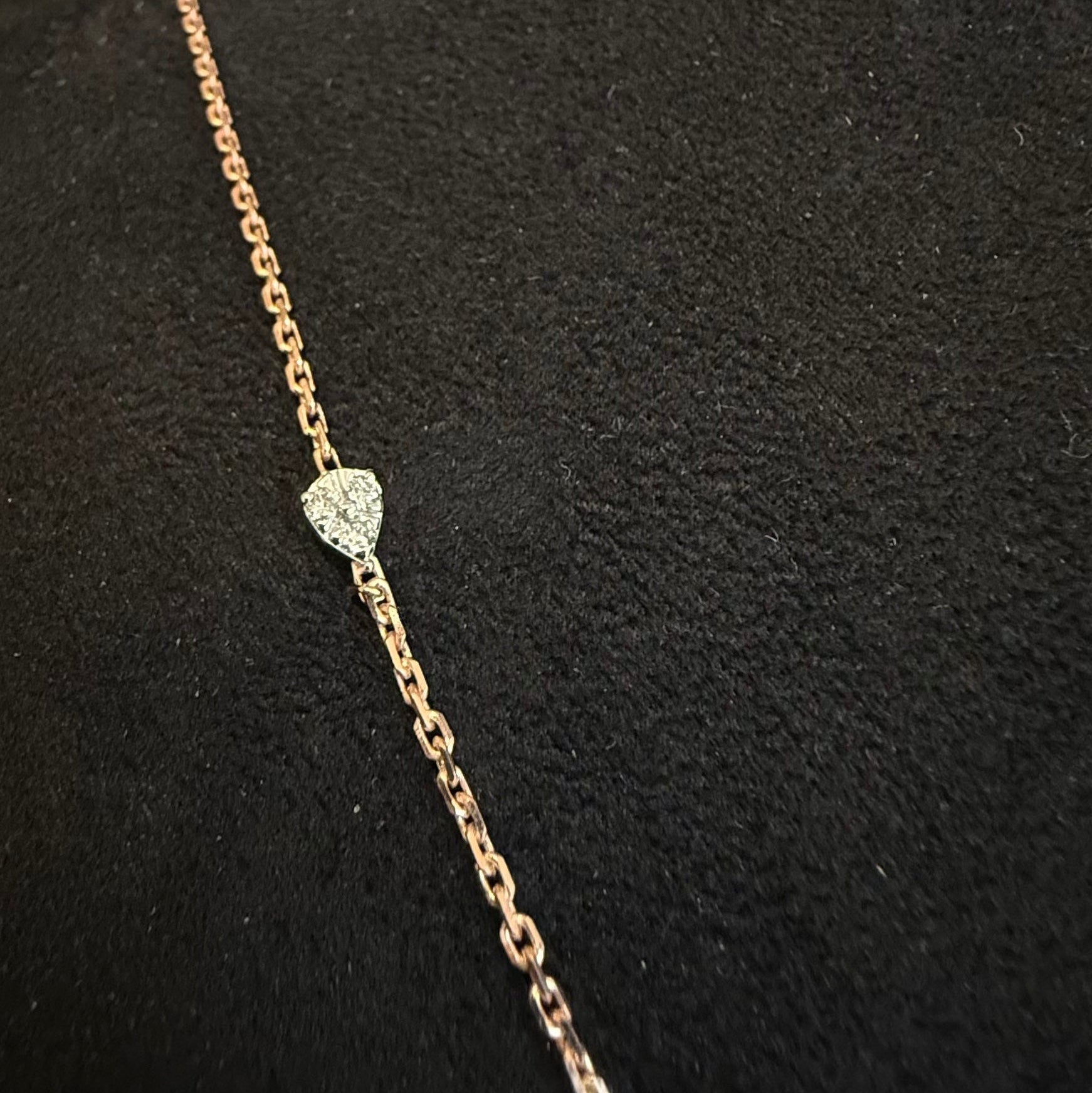 Gold chain necklace with a diamonds on a black background