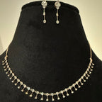 Jewelry set with necklace and earrings on a black velvet stand
