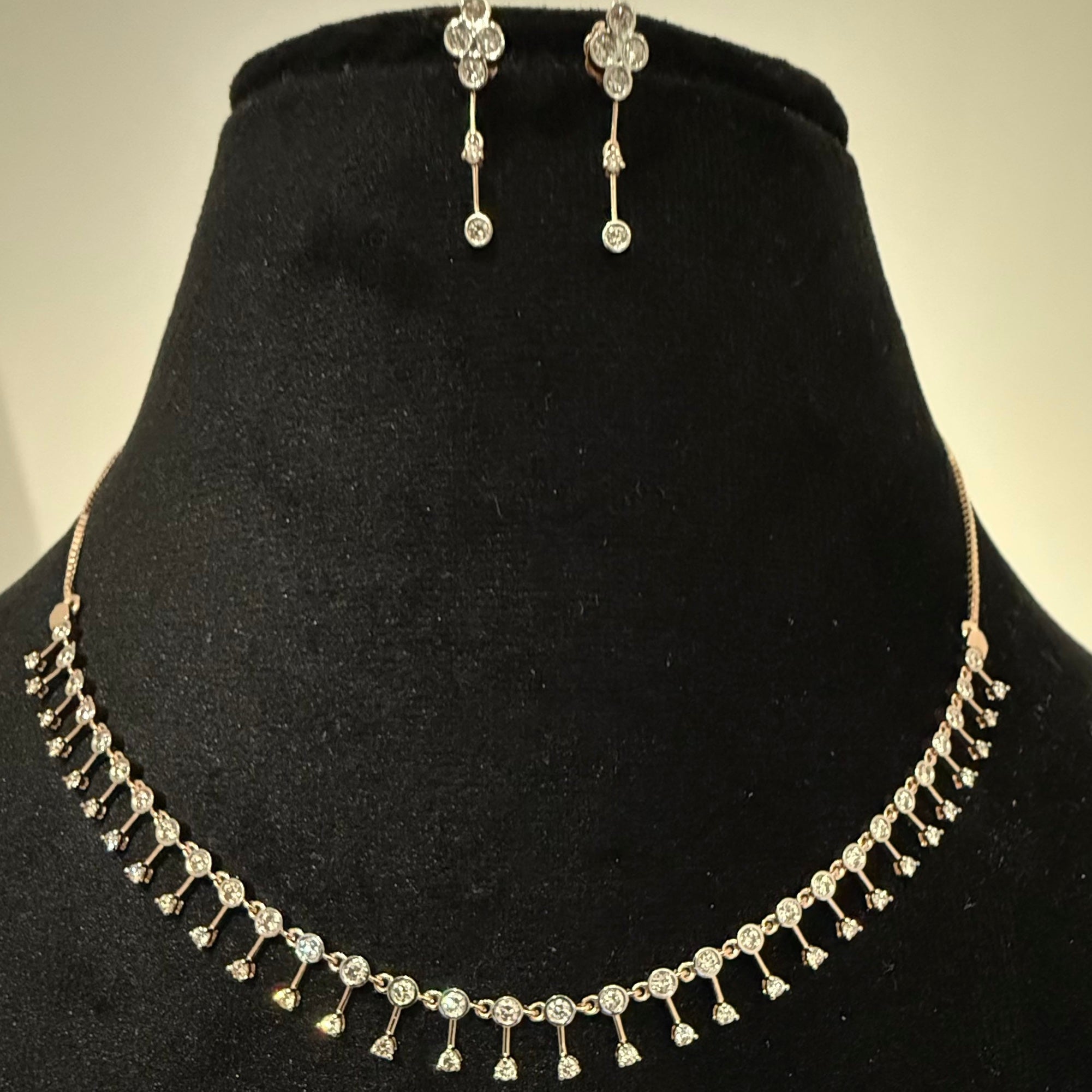 Jewelry set with necklace and earrings on a black velvet stand