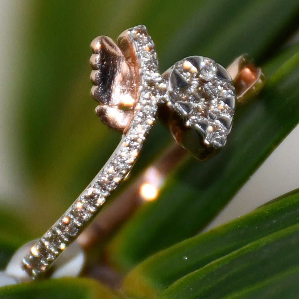 Close-up of a pave set diamonds gold ring with leaves on a green leafy background