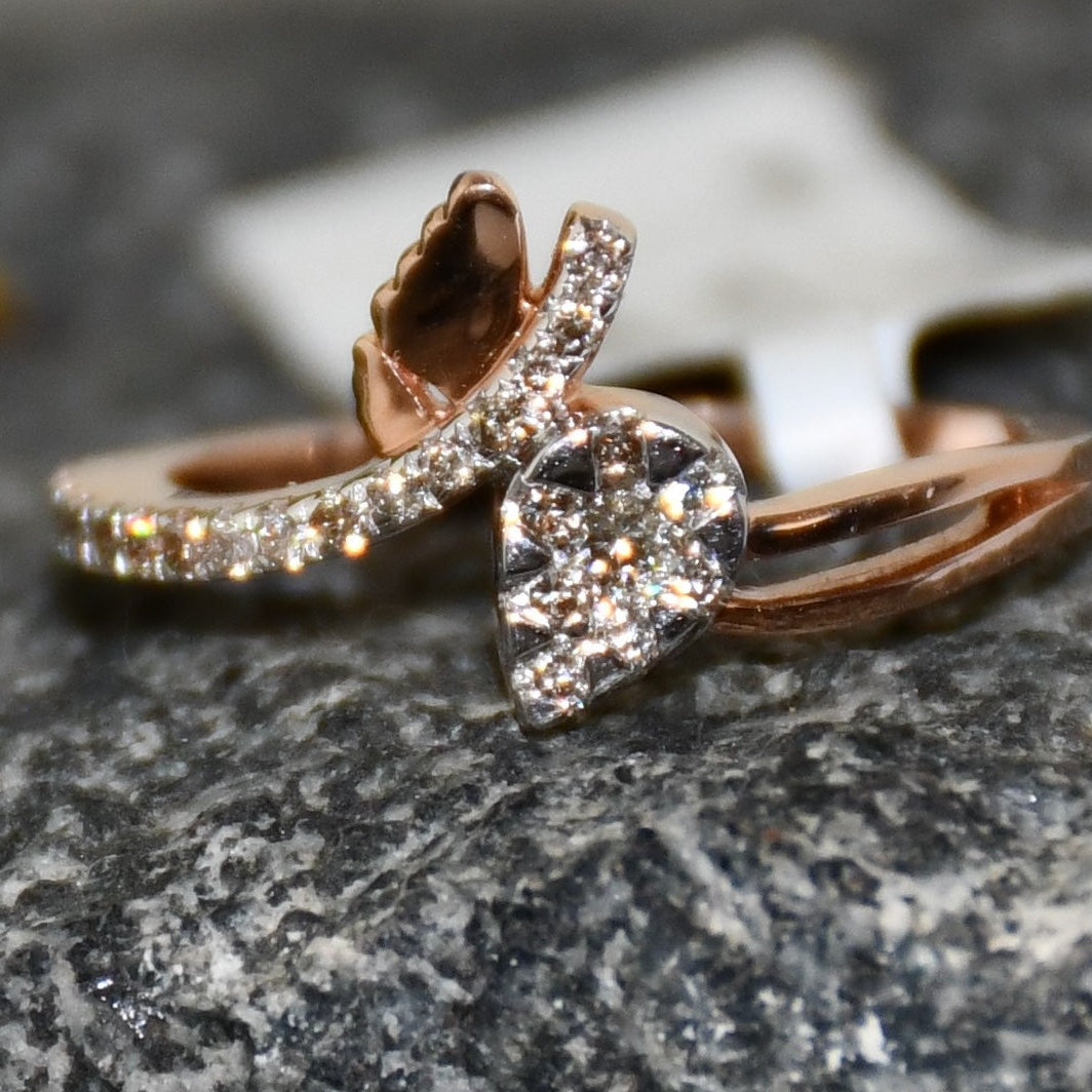 Rose gold ring with a pave set diamonds on a textured surface