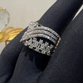 Gold ring with diamond accents on a black fabric background