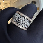 Gold ring with diamond accents on a black glove