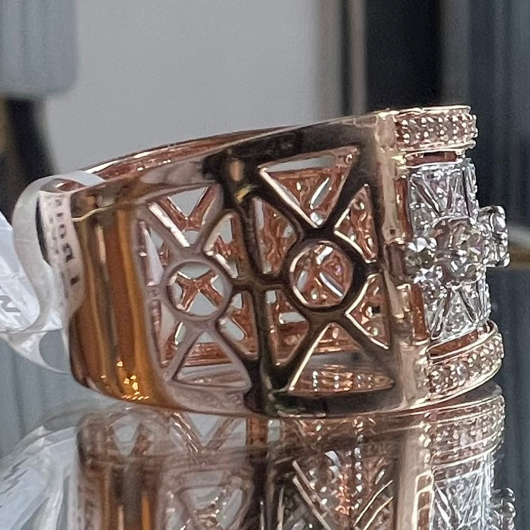 Gold diamond ring with intricate design on a reflective surface