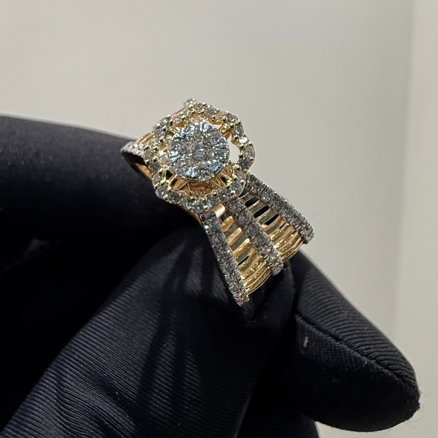Gold ring with a diamonds on a black glove