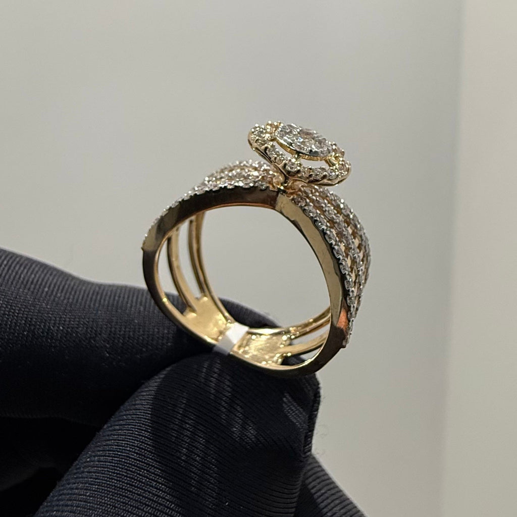 Gold ring with diamond accents held on a black cloth against a gray background