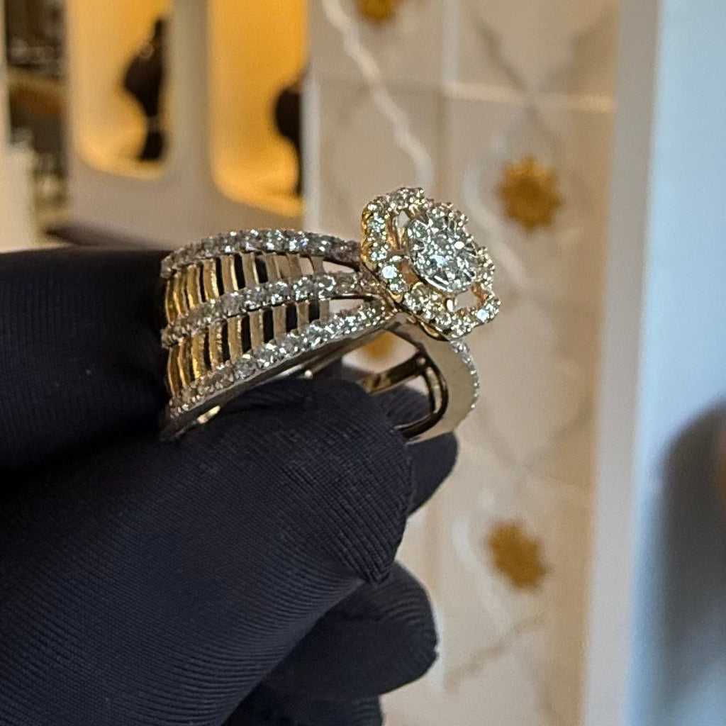 Diamond ring held by a gloved hand against a blurred background