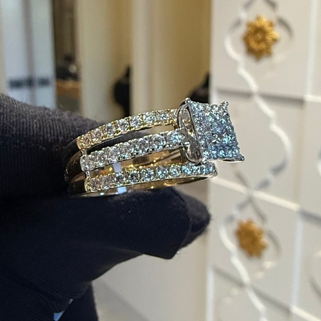 Diamond ring held by a gloved hand with a blurred background